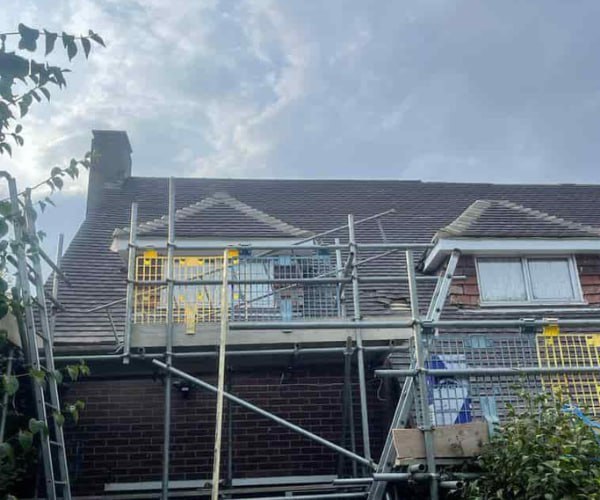 This is a photo of a roof with two dormers that is having some damaged tiles replaced. Works carried out by ATC Roofing Bromham