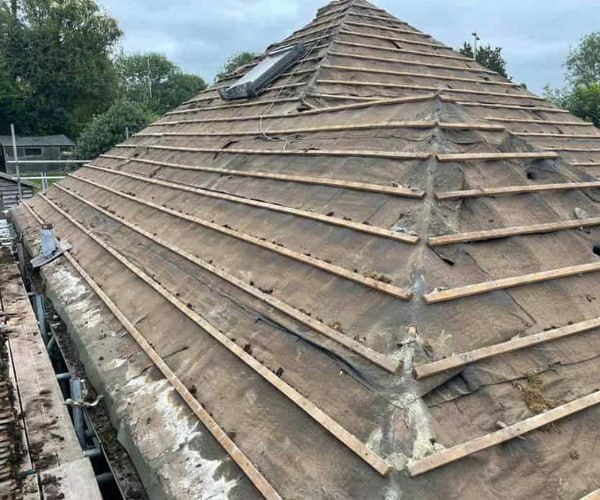 This is a photo of a hip roof that has been stripped back to the battens, and is awaiting a new roof covering to be installed. Works carried out by ATC Roofing Bromham